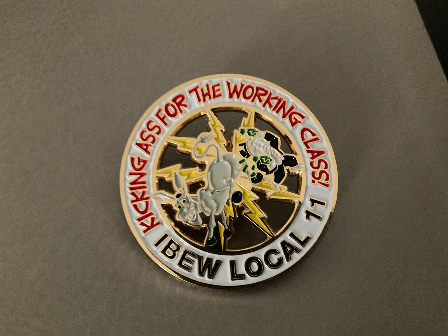 Kicking ass for the working class pin
